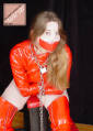 Dorothy Laine in red PVC straitjacket